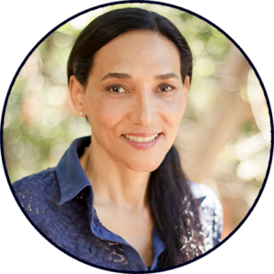Smiling woman outdoors with natural background.